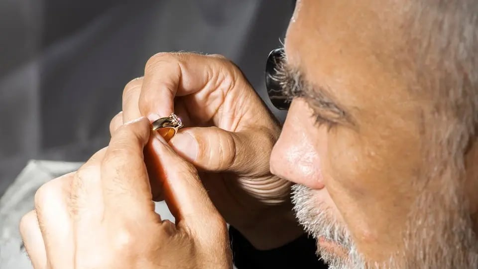 jeweler-inspecting-engagement-ring