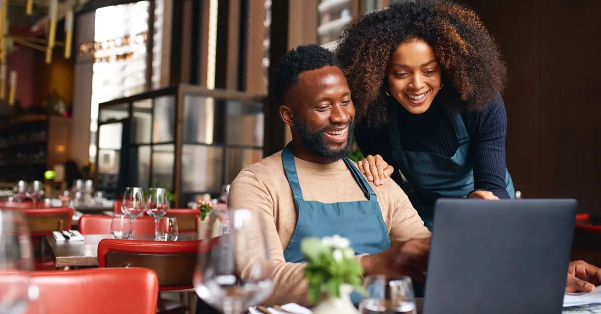Restaurant business owners on laptop