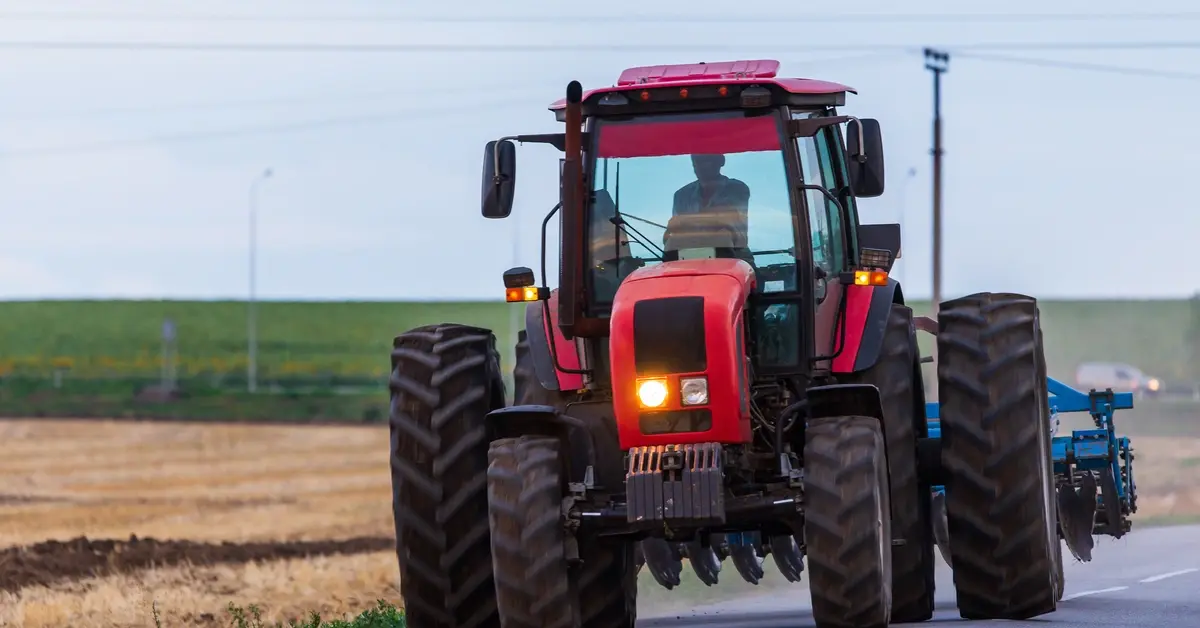 Tractor coming off of the field and onto the road